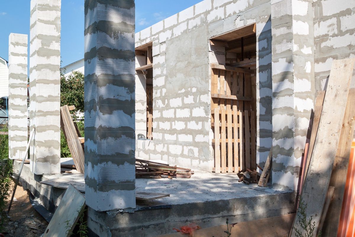 concept of alteration of construction at customer's request. Load-bearing columns made of foam block are taken out of  perimeter of foundation by 10 centimeters to increase space on veranda